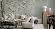 a living room filled with furniture next to a wall covered in flowers and birds on it