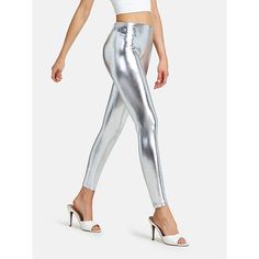 a woman in silver metallic pants and heels