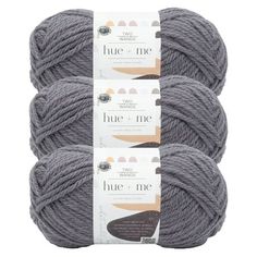 three skeins of blue - me wool yarn in grey, on white background