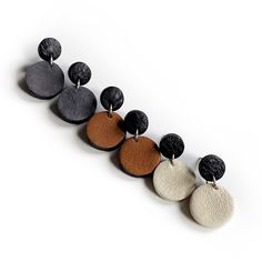 Don’t let its simple design delude you. Minimalist luxe earrings in rich earth tones will easily become your fave go-to. Basic shapes of uncomplicated neutrals modernize any outfit to give intention. With a pleasant feel, the delicate leather grain adds quiet character. Suspended circles add sweet movement. Circles symbolize wholeness. On a visual level, they promote a state of CALM & HARMONY. Feel complete & together as you restore your equilibrium. Beware, these adornments might make your thro Simple Leather Earrings, Quiet Character, Luxe Earrings, Leather Stud Earrings, Cricut Jewelry, Diy Leather Earrings, Clay Things, Leather Jewellery, Upcycled Leather