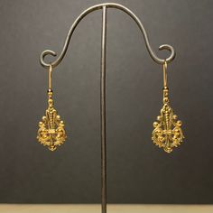 Here is a pair of cute, little, very light ornate dangle earrings.  These were actually made in the early seventies. They are good quality, new (unused) vintage items, made of gold plated brass. 13mm wide x 36mm high (with earwire) BOX06 IMPORTANT: please note that I offer different earwires as seen in second picture, and the price of the earrings vary depending on the chosen earwires.  It goes as follows: A: gold plated base metal french wires with ball (rubber stoppers included).  B: gold plat Gold-tone Dangle Clip-on Earrings, Gold Metal Dangle Clip-on Earrings, Antique Yellow Gold Drop Earrings, Gold-tone Gold-plated Pierced Earrings, Victorian Yellow Gold Drop Earrings, Single Gold-plated Gold-tone Earring, Victorian Gold Plug Earrings, Gold-tone Gold-plated Plug Earrings, Gold-tone Gold Plated Plug Earrings