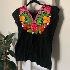 Hand-Embroidered Blouses Made In Oaxaca, Mexico. Brand New. Fits Like A Small Or Medium. Pink V-neck Top With Floral Embroidery, Pink Short Sleeve Embroidered Cotton Top, Casual Pink V-neck Embroidered Top, Traditional Black Embroidered Top For Spring, Black Crew Neck Blouse With Floral Embroidery, Pink Casual Embroidered Top With Short Sleeves, Casual Pink Embroidered Top With Short Sleeves, Casual Pink Short Sleeve Embroidered Top, Spring Black Blouse With Geometric Embroidery