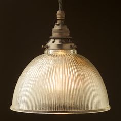 an old fashioned glass light hanging from a ceiling