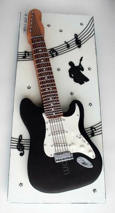 a guitar cake with musical notes on it