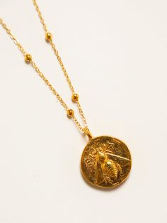 Bee of Ephesus/Stag Coin Necklace | Elysian by Emily Morrison. Yellow Gold Brass Medallion Charm Necklace, Tarnish Resistant Brass Pendant Charm Necklace, Handmade Yellow Gold Round Pendant Medallion Necklace, Handmade Yellow Gold Medallion Necklace With Round Pendant, Gold-tone Medallion Amulet Necklace, Yellow Gold Brass Amulet Charm Necklace, Yellow Gold Brass Amulet Charm Necklaces, Symbolic Gold-plated Medallion Necklace, Gold-tone Medallion Necklace In Amulet Style