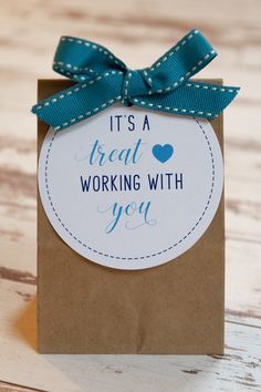 it's a great working with you gift card in a brown paper bag on a wooden table