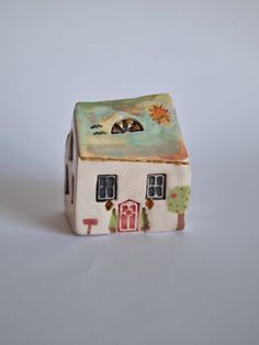 a ceramic figurine with a house on it