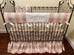 a baby crib with pink and white checkered bedding on the bottom row