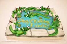 there is a birthday cake with alligators on it