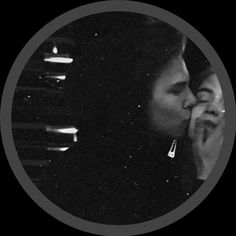 a man and woman kissing each other in the dark