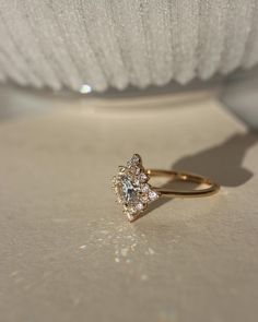 a diamond ring sitting on top of a table