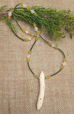 Unique and very rare little silver birch root talismanic necklace. On a necklace chain of moss green seed beads, set with pale green crystal, yellow chalcedony and beautiful 8mm white jade beads. And one lightly dotted silver birch root double terminated talismanic point. The tree of light and hope, of renewal and nurture, like all roots, this piece holds unformed and unshapen energy, an energy that can be shaped according to the desires of the wearer. This piece holds blinding white energy,, a Holistic Hand-strung Jade Jewelry, White Amulet Jewelry For Meditation, Jade Amulet Necklaces For Healing, Jade Amulet Necklace For Healing, Unique Green Necklace With 108 Beads, Bohemian Single Strand Jade Beaded Necklace, White Hand-strung Amulet Necklace, Spiritual Single Strand Beaded Necklace, White Jade Necklace With Natural Stones