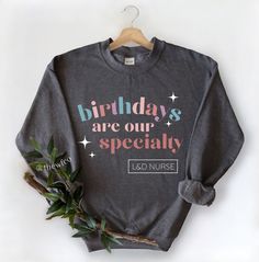 "A trendy Labor and Delivery Nurse Sweatshirt! This, \"Birthdays Are Our Specialty\" crewneck features pastel colors in a modern font. Like this design but need a different specialty? Check our other listings, or send me a message for a customized listing! This design on a T-SHIRT: https://www.etsy.com/listing/1168188205/labor-and-delivery-nurse-rainbow-shirt?click_key=f6827355dad4cdcd2adf8b5b9acf21f775d5f0df%3A1168188205&click_sum=2b28ce73&ref=related-6&pro=1&frs=1 D E T A I L S Casual Cotton Sweatshirt For Birthday, Birthday Long Sleeve Tops With Lettering, Birthday Tops With Lettering And Long Sleeves, Casual Long Sleeve Birthday Sweatshirt, Birthday Sweatshirt With Graphic Print In Relaxed Fit, Birthday Letter Print Relaxed Fit Sweatshirt, Trendy Crew Neck Tops For Birthday, Relaxed Fit Letter Print Sweatshirt For Birthday, Trendy Crew Neck Sweatshirt For Birthday