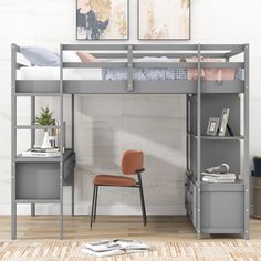 a loft bed with desk and chair in the corner, next to a white wall