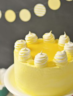 a yellow cake with white frosting on a plate