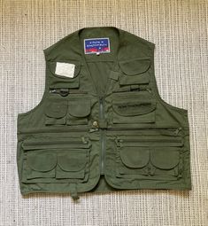 This is a great vintage y2k vest. Great for everyday wear and layering.  Size: M Measurements of it laying flat: length - 54cm/ 21.2in pit to pit - 58cm/ 22.8in .. Military Cotton Vest With Cargo Pockets, Utility Vest With Pockets For Streetwear, Utility Denim Vest With Pockets, Sleeveless Denim Vest With Pockets For Streetwear, Y2k Sleeveless Vest For Streetwear, Y2k Sleeveless Streetwear Vest, Utility Cotton Vest With Multiple Pockets, Military Style Sleeveless Vest With Cargo Pockets, Military Style Sleeveless Vest With Pockets