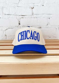 **Exclusive A&W Design** New! Show Chicago some love with this exclusive embroidered Chicago in Cubs blue on a natural base and blue brimmed baseball cap. Adjustable snapback enclosure. One size fits most. Trendy Flat Brim Baseball Cap, Trendy Flat Brim Baseball Cap For Baseball Season, Hip Hop Style Snapback Hat For Baseball Season, Hip Hop Curved Bill Snapback For Baseball Season, Everyday Snapback Trucker Hat With Embroidered Logo, Trendy Flat Brim Snapback Hat For Baseball Season, Blue Snapback Baseball Cap With Embroidered Logo, Blue Embroidered Logo Snapback Baseball Cap, Blue Embroidered Logo Snapback Hat