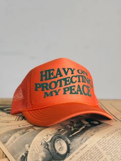 Rock HEAVY OF PROTECTING MY PEACE Trucker Cap and make a statement. HEAVY ON PROTECTING MY PEACE printed on front 4" high crown Available in black, orange, green, red Snap back adjustable closure Orange Trucker Snapback Hat, Orange Trucker Hat, One Size Fits Most, Orange Trucker Baseball Cap One Size, Orange Snapback Trucker Hat For Outdoor, Adjustable Orange Hat With Letter Print, Orange Trucker Hat For Streetwear, Orange Snapback Trucker Hat For Sports, Orange Snapback Hats For Streetwear, Orange 5-panel Adjustable Trucker Hat