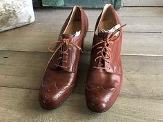 "Vintage Leather Oxford Shoes, 1940s 50s 7 - 8 US Chestnut brown leather oxford shoes from the late 40s, early 50s. Chunky 3\" heels. Leather soles and insoles. The owners name is written on the inside and dated 1954. We are selling a few pairs of the same size from this estate. Measure; 9.5 \" insoles, 9.75\" sole, 3\" width (narrow), 3\" heels. Shoe size is not marked, so please check all measurements well. Possibly a size 7 - 8 US with a narrow width. Good condition with creasing and wear to Vintage Oxfords For Office In Fall, Vintage Oxfords For Fall Office Wear, Retro Wingtip Oxfords For Fall, Vintage Brogue Oxfords For Fall, Retro Oxfords With Brogue Detailing For Work, Retro Brogue Oxfords For Work, Retro Almond Toe Oxfords For Workwear, Vintage Oxfords With Leather Sole For Fall, Retro Formal Oxfords With Leather Sole