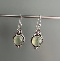 Sterling silver oval Prehnite earrings . Beautiful pale green colour. Healing stone. ♥ Truth ♥ Calmness ♥ Sincerity ♥ Sensitivity Prehnite is considered a stone of unconditional love and the crystal to heal the healer.  It enhances precognition and inner knowing.  Enables you always to be prepared.  Prehnite calms the environment and brings peace and protection.  Perfect Valentines day gift or for any occasion. Gift box available for purchase. Search GIFTBOX Silver And Green Earrings, Colour Healing, Silver Earrings Aesthetic, Boho Jewelry Earrings, Inner Knowing, Silver Crystal Earrings, The Healer, Earrings Teardrop, Green Earrings