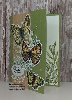 two cards with butterflies on them, one is green and the other is brown in color