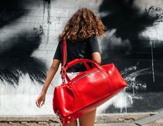 "Our leather duffle bags are the perfect weekend bags to carry for both function and style. Large, sustainable and timeless good - bought once and for all! Several meters of genuine red leather turned into a modern travel bag handcrafted individually for you! Short trips or long-term voyages, business assignments and round-the-city walks, there isn't a situation where this large bag will let you down. It can be used for almost all purposes - as a luggage bag, a camp bag, a gym bag, an overnight Weekend Bags, Leather Laptop Case, Leather Duffle Bag, Red Bag, Camping Bag, Leather Duffle, Duffle Bags, Tablet Sleeve, Duffel Bags