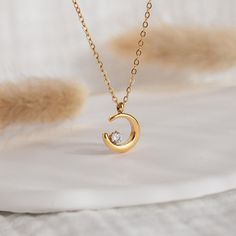 Gold Crescent Moon with Cubic Diamond Necklace, Dainty Half Moon Pendant, Women's Jewelry, Gift for Her, Celestial Jewelry, Moon Lovers Gift PRODUCT DETAILS ✦ 18K Gold plated over surgical level 316L stainless steel ✦ Lead-free and Nickel-Free, a great choice for sensitive skin ✦ Hypoallergenic ✦ Tarnish-Free  ✦ WATERPROOF and SWEAT-RPOOF SOLD Separately Small Pendant: 14 mm Big Pendant: 17 mm  Cubic Zirconia Diamond Chain Length:  16 in + 2 in extender (classic cable chain) SHOP The Star Layeri Gold Crescent Moon, Moon Lovers, Celestial Jewelry, Diamond Chain, Necklace Dainty, Small Pendant, Moon Pendant, Lovers Gift, Women's Jewelry