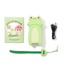 a green frog bookmark with an earphone attached to it next to a usb cable