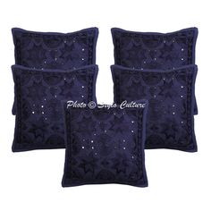 three blue pillows with beading on them