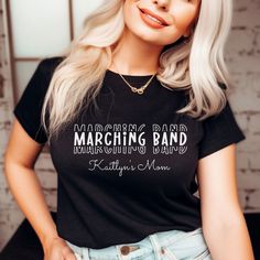 Introducing our Marching Band Mom t-shirt, perfect for high school band moms! The minimalist design features repeating font of "Marching Band" in white text on a black t-shirt and has optional customizable text underneath. Made with high-quality materials, this t-shirt is comfortable and durable for everyday wear. Show off your pride for your child's passion with this stylish and eye-catching t-shirt. Order now and become the ultimate Marching Band Mom!

Slight variances in color and size are no Marching Band Mom, Band Mom, High School Band, School Band, Fan Shirts, Marching Band, Black T Shirt, Black Tshirt, Fashion Clothes Women