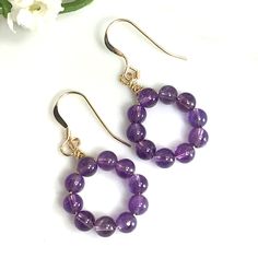 ✦Gemstone: Natural Amethyst ✦Material: 14k Gold Filled  ✦Color: Purple ✦Bead Size: 4mm ✦Shape: Round ✦Earring length: 1.5'' ✦QTY: 1 Pair earring / package ♕Beautiful & High Quality Findings♕ Crafted with true natural stones, these earrings are individually unique. These wire wrapped dangle earrings make the perfect gift for a simple yet distinct jewelry lover. Earrings measure 1.5 inches from top of ear wire to bottom of bead and each is hand-wrapped individually. The stone beads used are 4mm in diameter and ten beads in each earrling. The hooks are 14K gold-plated that are hypoallergenic and safe for sensitive skin. We also have Natural Amethyst Jewelry set available. The set contains one pair of wire wrapped earrings and one necklace. Please visit our store for necklace info. and contact Purple Hypoallergenic Round Jewelry, Purple 14k Gold Filled Jewelry As A Gift, Purple Round Beaded Jewelry For Mother's Day, Purple 14k Gold Filled Jewelry Gift, Purple Hypoallergenic Jewelry For Birthday, Purple Jewelry For May Birthstone Gifts, Elegant Purple Jewelry For Birthday, Amethyst Birthstone Drop Earrings, Purple Gemstone Jewelry For Birthday