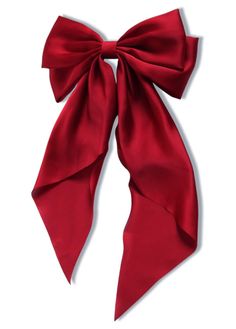 a red bow tied to the side of a white wall