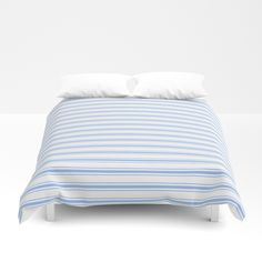 a blue and white bed with two pillows