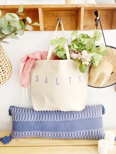 "The SALTY Oversized canvas tote bag is perfect for a trip to the beach! Also perfect to use as a reusable shopping bag, or everyday carryall. Available with text in several colors... check out the variations! This bag is made from 100% thick, sturdy canvas. AVAILABLE IN TWO SIZES * Large - 19.5\" x 13\" with a 4\" gusset *Jumbo - 23\" x 13\" with a 6\" gusset These bags are hand painted using non-toxic fabric paint. The technique used creates an attractive distressed appearance to the text that Summer Cotton Beach Bag For Shopping, Summer Cotton Canvas Shopping Bag, Trendy Cotton Canvas Bag For Beach Season, Beachy Cotton Tote Bag, Beach Season Cotton Canvas Tote Bag, Lavender Bags For Daily Use In Summer, Beachy Rectangular Cotton Bags, Summer Canvas Bag With Letter Print For Shopping, Summer Cotton Canvas Bag With Letter Print