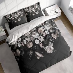 a bed with black and white flowers on it