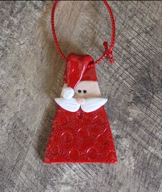 a red ornament with a santa clause on it