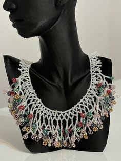 This beautiful listing is a handmade Flower bead necklace. It's made with high quality Czech glass beads. It's suitable for any occasion and as well perfect for a gift.    This product incudes: - Color: White, red, gold, green, etc.  - Length - 43.2 сm / 17 inches (including necklace closure hook)   Materials:  - Czech "Preciosa" beads - Durable synthetic thread - Gold colored stainless steel closure hooks    PACKAGING & SHIPPING - Your item will be delivered in a beautiful pouch bag. Multiple products will be shipped in the same pouch bag unless requested in the note section. -- Gift wrapping and gift boxes available at checkout. - Your order will be carefully packed and shipped with tracking. Your tracking number will be communicated by email as soon as your order ships. Bohemian White Beaded Necklaces With Dangling Beads, White Dangling Beads For Jewelry Making, White Dangling Beads For Gifts, White Beaded Necklace For Party, White Necklaces With Colorful Beads For Party, Unique White Beaded Chain Necklace, Multicolor Beaded Chain Flower Necklace, Multicolor Flower Necklace With Beaded Chain, White Necklaces With Dangling Round Beads