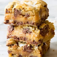 three pieces of chocolate chip cookie bars stacked on top of each other