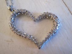 This fun and sparkly silver heart is covered in crystals! The charm hangs from a 16 inch siilver toned chain and measures 1 inches long. This is a great everyday necklace that will go with anything! Makes a great gift for a birthday or Valentine's Day too! Thanks for taking a look! Silver Heart Pendant Rhinestone Necklace For Party, Silver Heart Cut Necklace For Party, Silver Rhinestone Pendant Necklace For Valentine's Day, Silver Heart Rhinestone Necklace For Wedding, Silver Heart Shaped Rhinestone Necklace For Wedding, Silver Heart-shaped Rhinestone Necklace For Wedding, Silver Heart Necklace With Sparkling Stones, Silver Heart Pendant Rhinestone Necklace For Weddings, Silver Bling Necklaces For Valentine's Day