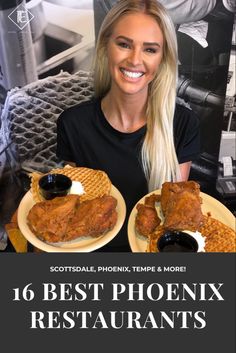 a woman sitting at a table with two plates of chicken and waffles