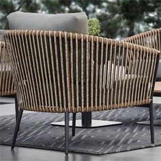 two wicker chairs sitting next to each other on top of a carpeted floor