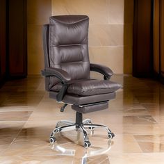 a brown leather office chair sitting on top of a tiled floor next to a wall