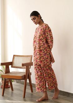 The set consists of printed shirt, 3/4th sleeves, collar neck teamed with printed palazzo pants. Fabric-Cotton Color-Peach Kurta Length length -28 inches Pant Length-38 inches Style - Floral Print detailing Neck - Collared neck Sleeves - 3/4th bell sleeves Model is wearing size small. She is 5.8‚Äù tall. Washing Care- Hand wash & Dry Clean Spring Workwear Long Sleeve Palazzo Set, Floral Print Cotton Pant Set With Long Sleeves, Pink Block Print Sets With Long Sleeves, Straight Kurta Sets With Printed Motifs For Work, Workwear Sets With Printed Motifs And Straight Kurta, Long Sleeve Sets With Printed Motifs For Loungewear, Long Sleeve Printed Sets For Workwear, Pink Long Sleeve Block Print Sets, Pink Long Sleeve Sets With Block Print