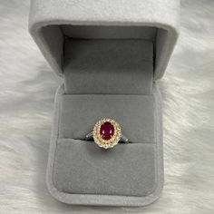 This deluxe designed ring is made out of a 8x6mm ruby stone and forty-six (46) white zircons. Also, the main material of the ring is S925 sterling silver plated with 18K gold. Ruby is a birthstone of July which represents nobility and passion. The oval shape of the deep red ruby stands out from the yellow gold and white zircons. The adjustable ring size is designed to fit all finger sizes. This piece of eye-catching jewelry is worthy to own by all women. Size: Adjustable and fitable for all All Heirloom Jewelry With Accent Stones For Proposal, Ruby Birthstone Jewelry For Proposal, Yellow Gold Rings With Halo Design In Sterling Silver, Yellow Gold Gemstone Jewelry For Proposal, Yellow Gold Gemstone Cluster Ring For Proposal, Proposal Jewelry In Yellow Gold With Gemstones, Halo Setting Proposal Ring, Yellow Gold Sterling Silver Ruby Ring As Gift, Yellow Gold Ruby Jewelry For Proposal