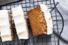 three slices of carrot cake on a cooling rack