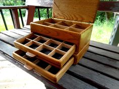 an open wooden box sitting on top of a table