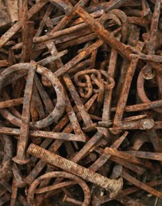 many rusty metal objects are piled together