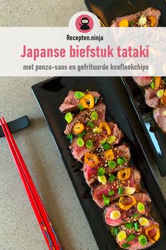 two black plates topped with meat and veggies next to chopsticks