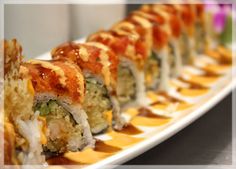 sushi rolls are arranged on a long plate