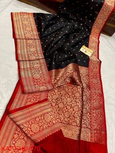 Extremely beautiful Pure katan Benarasi saree .Deep zed black body with red zariwoven border.Rich handcrafted zari work on border and pallu.Alloverbody has zari weaving polka dots. Saree is very pretty, light weight, with elegant look,silk quality is just awesome. Surely you will fall in love with the quality and texture of the saree when you get it on your hand. Saree has contrast BP. Best suited for weeding, party,puja,gifting. As the saree is completely handcrafted and will be made to order , Black Art Silk Saree With Traditional Drape, Diwali Black Tussar Silk Saree, Black Art Silk Dupatta With Pallu, Festive Black Saree With Pallu Detail, Black Saree With Pallu For Festive Season, Black Bollywood Saree With Zari Weaving, Bollywood Black Saree With Zari Weaving, Black Art Silk Saree For Diwali, Black Unstitched Saree With Pallu